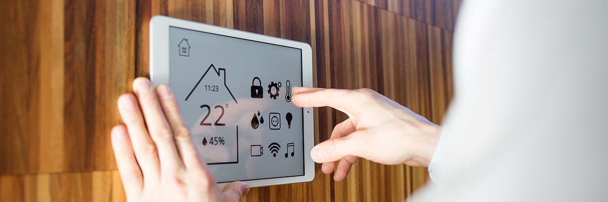 man controls smart home devices using digital tablet