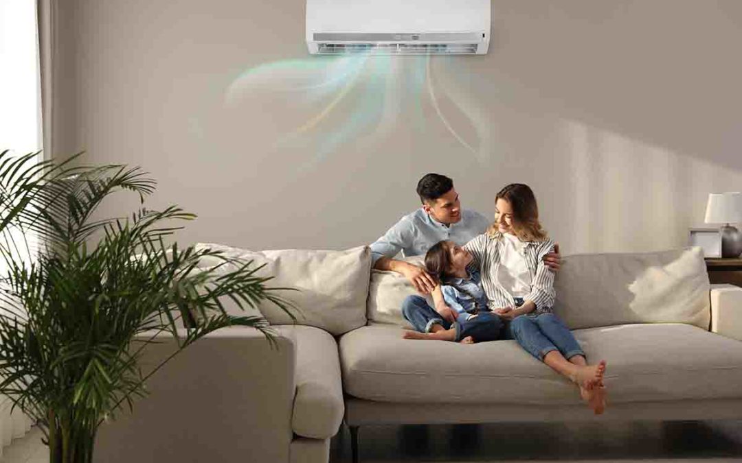 Happy family resting under air conditioner